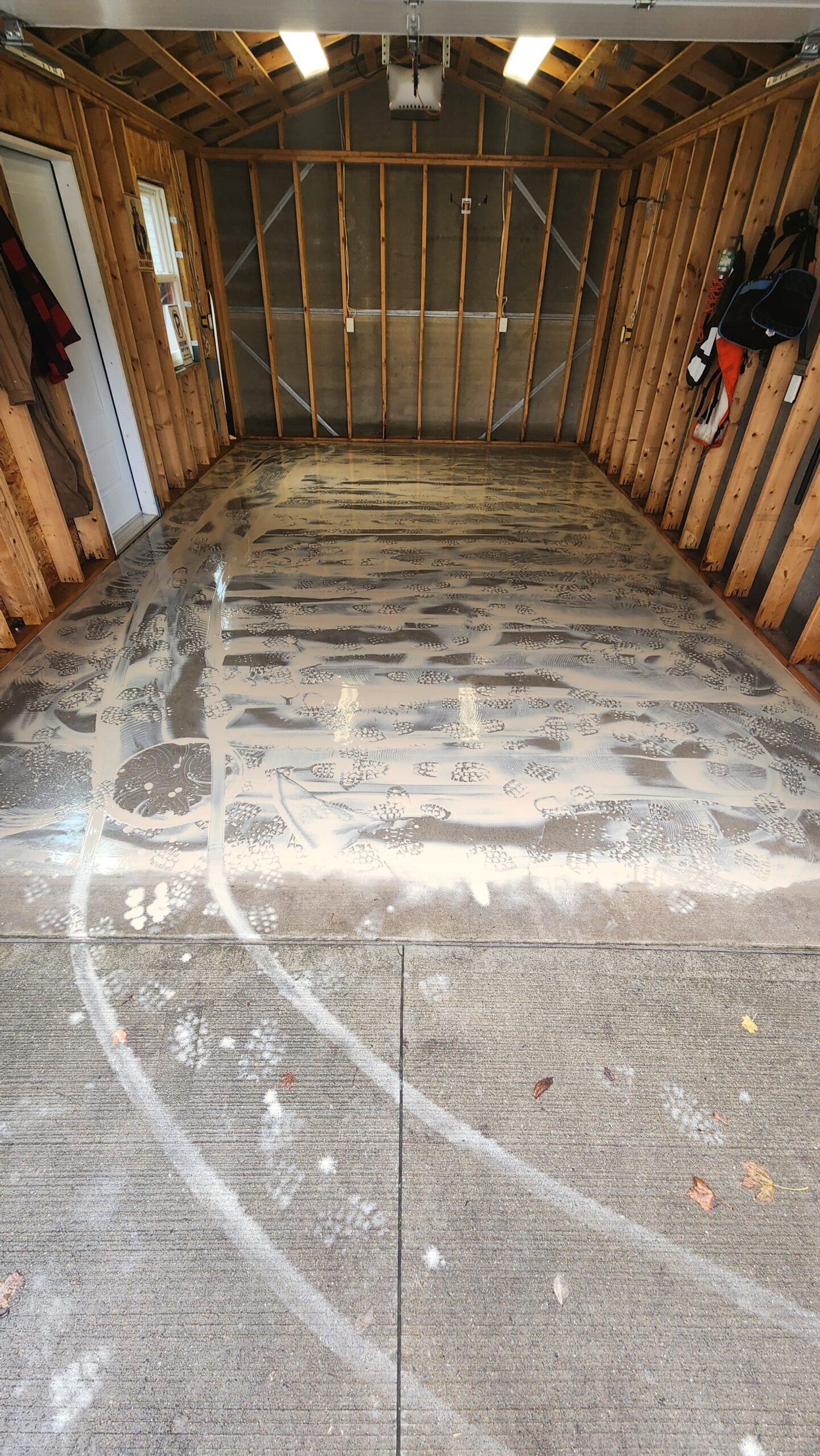 Industrial concrete grinding and leveling to repair an uneven garage floor.