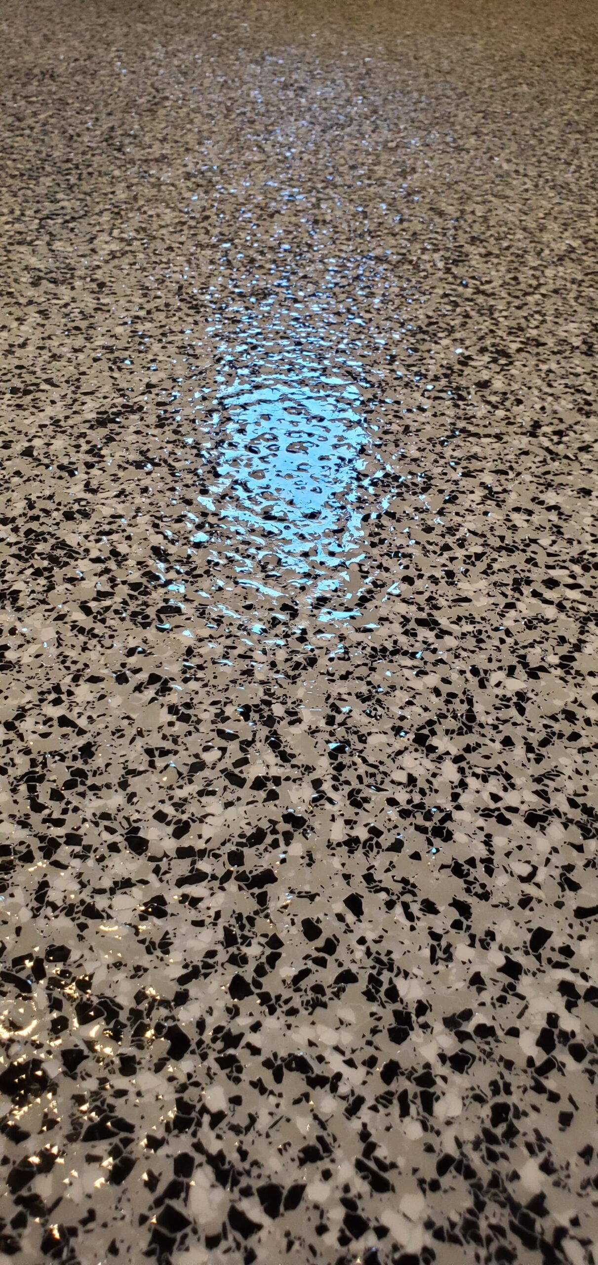 Professional grey epoxy garage floor coating with decorative vinyl flakes for a slip-resistant, durable finish in a Halifax home.