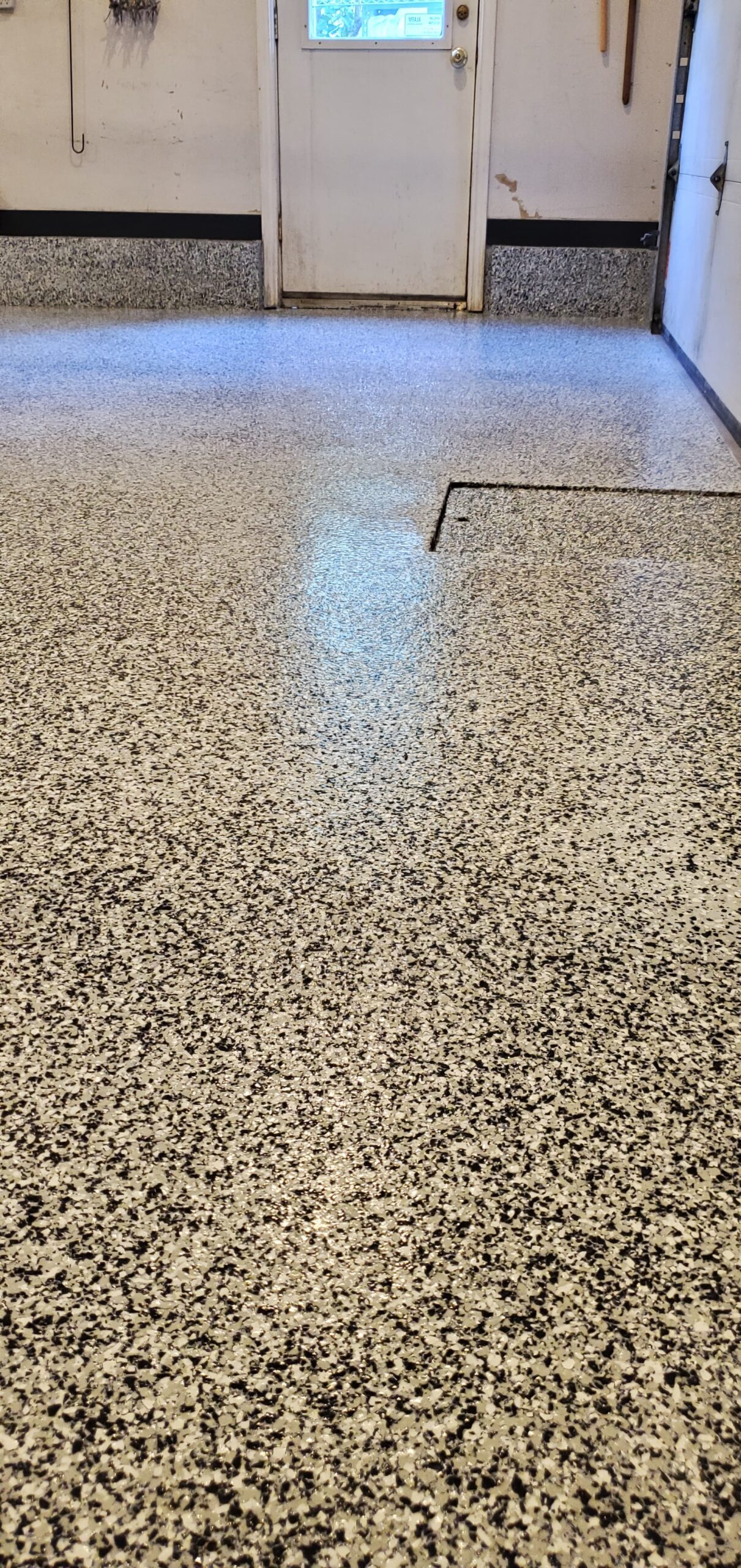 Multi-layered epoxy flake flooring system supplied and installed by Insta Flooring Ltd, perfect for heavy-duty garage and workshop use.
