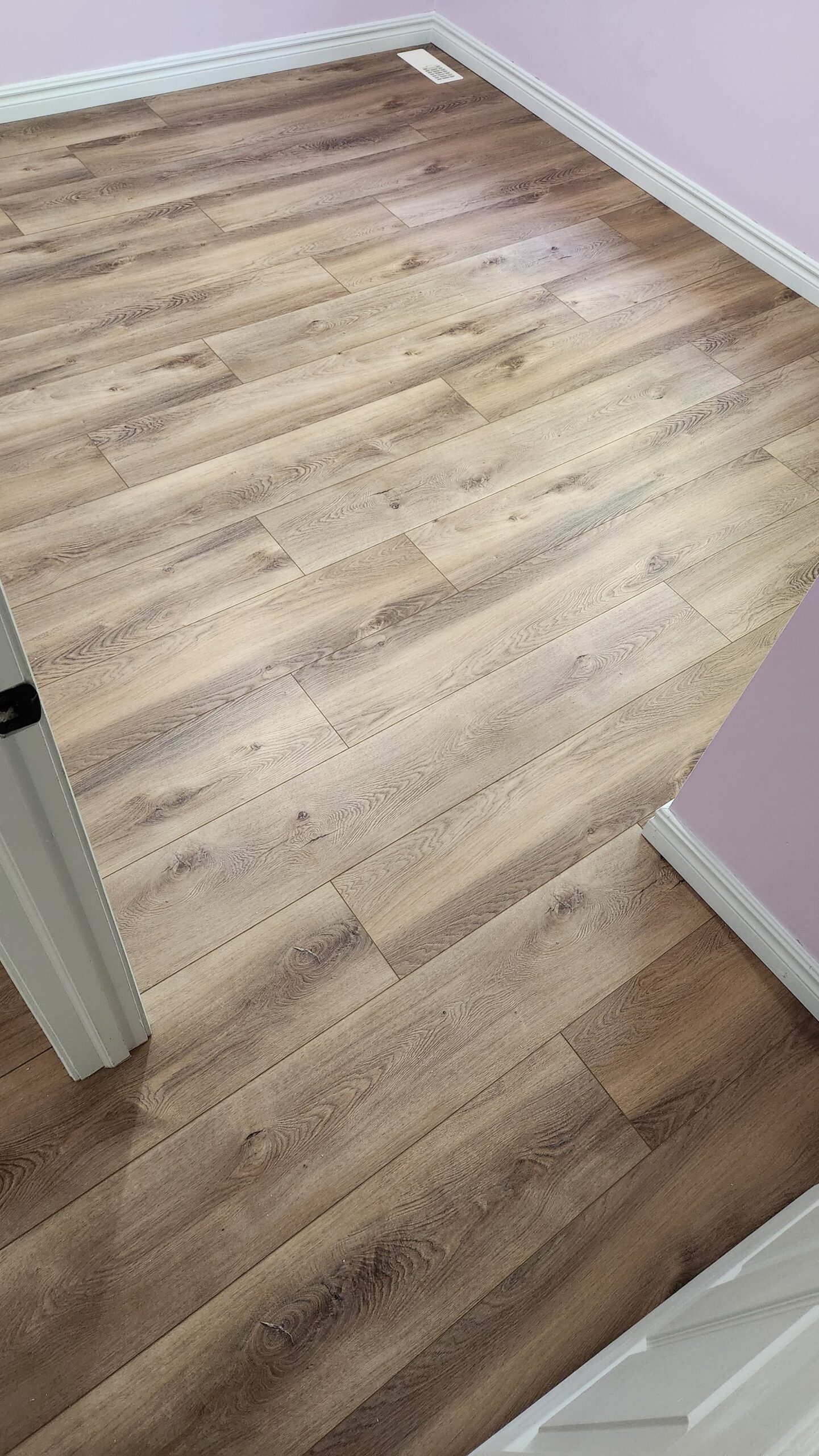 Modern grey luxury vinyl plank flooring supplied and installed in a Halifax home by Insta Flooring.